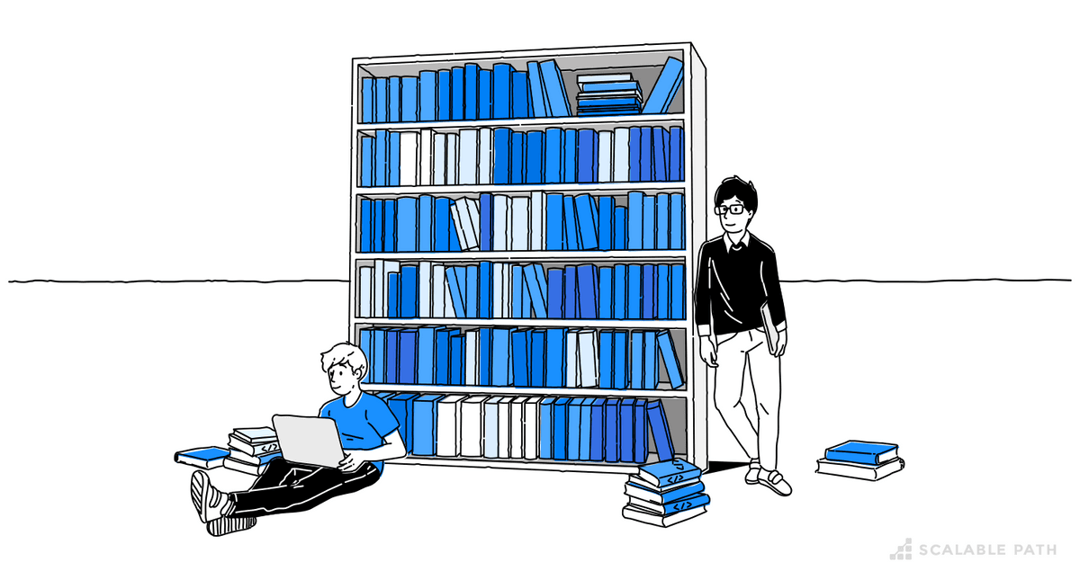 Two people next to a bookshelf full of books